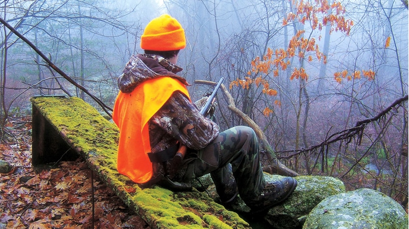 a hunter in orange clothing